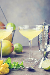 Margarita Mango alcoholic cocktail in a glass on stone background.