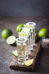 Mexican Gold Tequila with lime and salt on black background with copyspace.