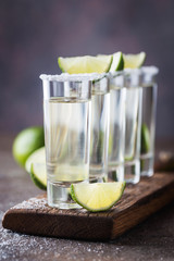 Mexican Gold Tequila with lime and salt on black background with copyspace.