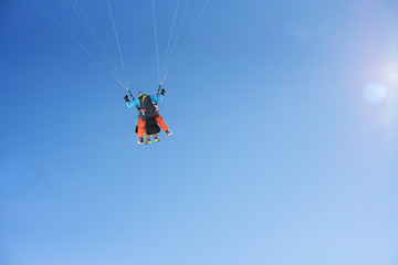 Fototapeta na wymiar Paragliding, cloudless blue sky
