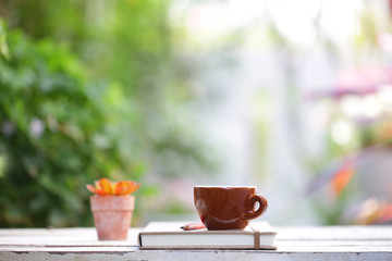 Small brown cup with small plant