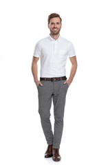 happy confident casual man standing with hands in pockets