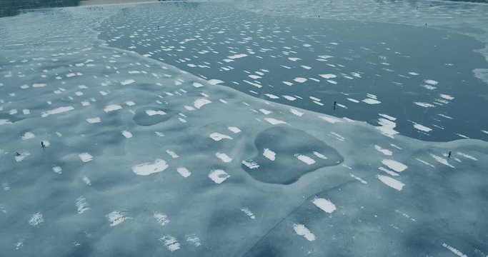 Aerial drone footage of frozen river in winter day.Flying quadro copter camera shoot video of ice on sea water surface in cold season.Beautiful landscape from above.Travel destination for tourism