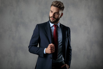 relaxed businessman holding suit's collar and hand in pocket