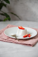 Vegan coconut Raspberry panna cotta decorated with ripe berry