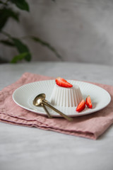 Vegan coconut Raspberry panna cotta decorated with ripe berry