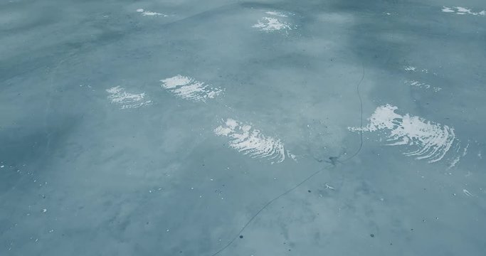 Aerial drone footage of frozen river in winter day.Flying quadro copter camera shoot video of ice on sea water surface in cold season.Beautiful landscape from above.Travel destination for tourism