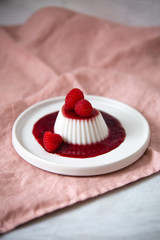 Vegan coconut Raspberry panna cotta decorated with ripe berry