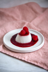 Vegan coconut Raspberry panna cotta decorated with ripe berry