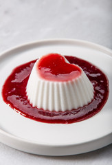 Vegan coconut Raspberry panna cotta decorated with ripe berry