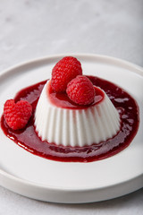 Vegan coconut Raspberry panna cotta decorated with ripe berry