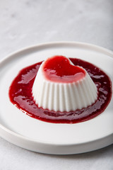 Vegan coconut Raspberry panna cotta decorated with ripe berry
