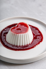 Vegan coconut Raspberry panna cotta decorated with ripe berry