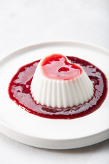 Vegan coconut Raspberry panna cotta decorated with ripe berry