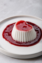 Vegan coconut Raspberry panna cotta decorated with ripe berry
