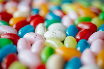 Colorful candy beans as texture and background. Close up view of jelly beans with selective focus. 