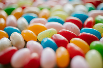 Colorful candy beans as texture and background. Close up view of jelly beans with selective focus. 