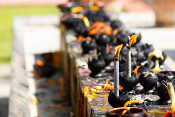 Candles in the temple. .Fire in lantern for pray with Buddha statue in temple.