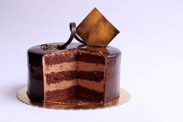 Tasty little chocolate cake with piece take out.