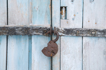 old wooden door with an old rusty padlock