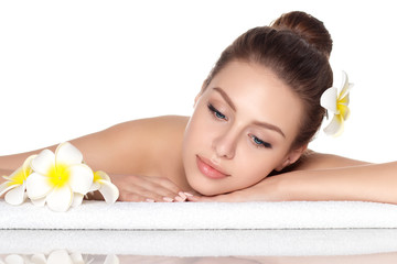Obraz na płótnie Canvas Portrait of young beautiful woman laying in spa salon isolated over white background. SPA therapy, skincare, recreation and cosmetology concept