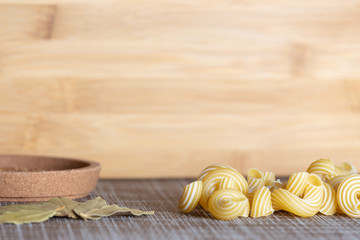 Food set on the table with pasta and bay leaf