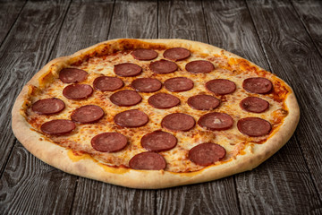 Pizza pepperoni on wooden table close up