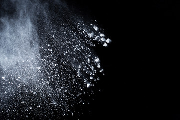 White powder explosion on black background. Colored cloud. Colorful dust explode. Paint Holi.