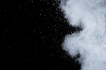 White powder explosion on black background. Colored cloud. Colorful dust explode. Paint Holi.