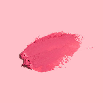 Creative concept photo of cosmetics swatches on pink background.