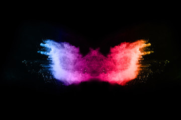 abstract colored dust explosion on a black background.abstract powder splatted background,Freeze motion of color powder exploding/throwing color powder, multicolored glitter texture.