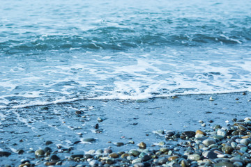 Beautiful foam waves on a sunny day in the Aegean Sea on the island of Evia in Greece