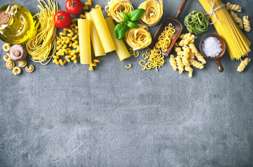 Various pasta over stone background