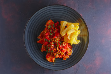 Portuguese  goulash with tomato and olives sauce and fried potato