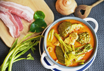 Thai streaky pork red curry with morning glory (Thai name is Kaeng Thepho). Thai red curry soup with fresh ingredient.