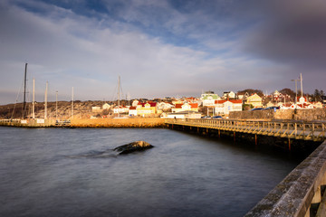 Fototapeta premium Saltholmen houses immersed in golden light during evening sunset at gothenburg Sweden