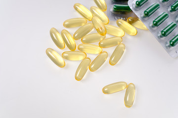 yellow fish oil capsules, omega 3, on white background