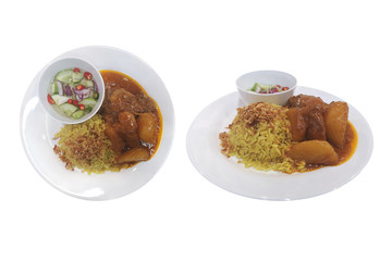 Massaman curry with chicken  and potatoes.Food with spices served with steamed turmeric jasmine rice. Eaten together with pickled vegetables. Isolated on white background with clipping path.