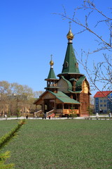 OMSK, RUSSIA - MAY 6, 2009: Chopped wooden church in tent style. Russian architecture. The Church of All Saints in Omsk.
