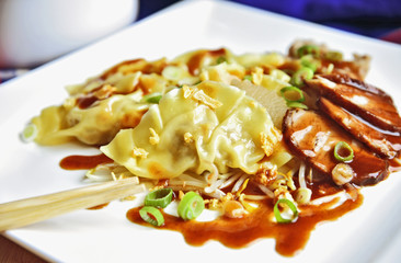 Wonton or dumpling with BBQ pork and BBQ red sauce.