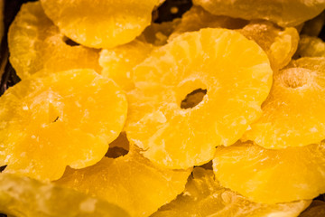 Bright yellow background or texture. Tropical dried fruit the pineapple cut on rings. Summer and exotic. Vitamins and useful fruit