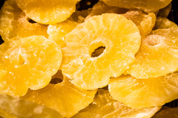 Bright yellow background or texture. Tropical dried fruit the pineapple cut on rings. Summer and exotic. Vitamins and useful fruit