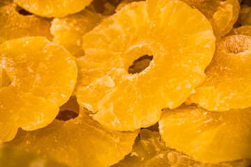 Bright yellow background or texture. Tropical dried fruit the pineapple cut on rings. Summer and exotic. Vitamins and useful fruit