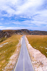 Aerial view on transalpina road on Romania mountain, travel, adventure concept, motorcyclists way, vacation place, mountains top, autumn day, vertical photo