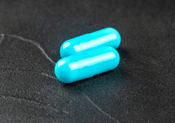 Two blue capsules