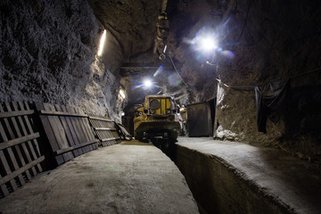 Underground gold ore mine shaft tunnel gallery passage with load, haul, dump machine LHD