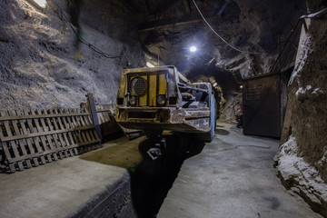 Fototapeta na wymiar Underground gold ore mine shaft tunnel gallery passage with load, haul, dump machine LHD