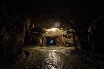 Fototapeta na wymiar Underground gold ore mine shaft tunnel gallery passage with gate