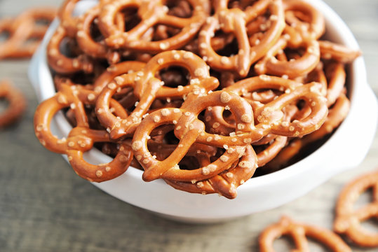 Hard Pretzels or Salted pretzels snack for party in white bowl on wooden floor.