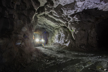 Underground gold ore mine shaft tunnel gallery passage with LHD machine